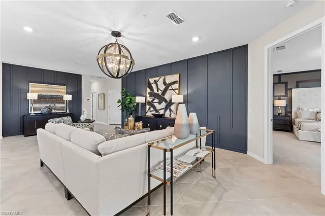 a living room with furniture a dining table and a clock