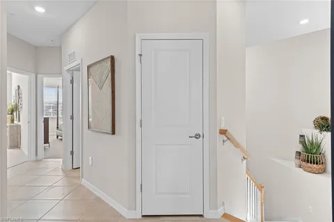 a kitchen with kitchen island granite countertop a sink cabinets and living room view