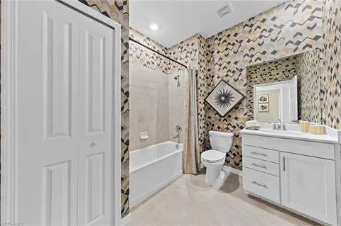 a spacious bedroom with a bed and window