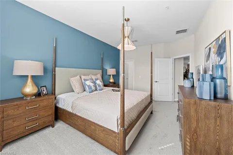 a spacious bedroom with a bed and a couch