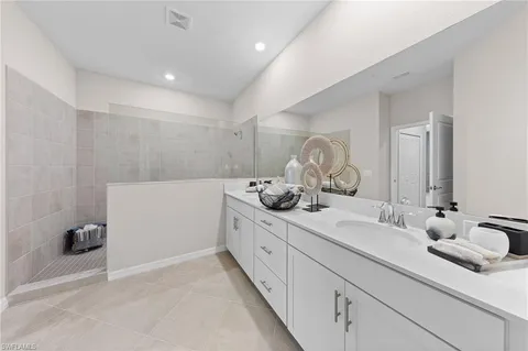 a bedroom with bed and a chandelier