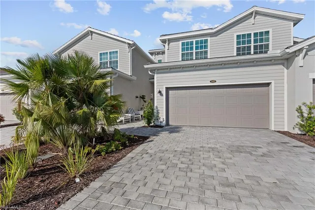 a dining room with furniture and a floor to ceiling window