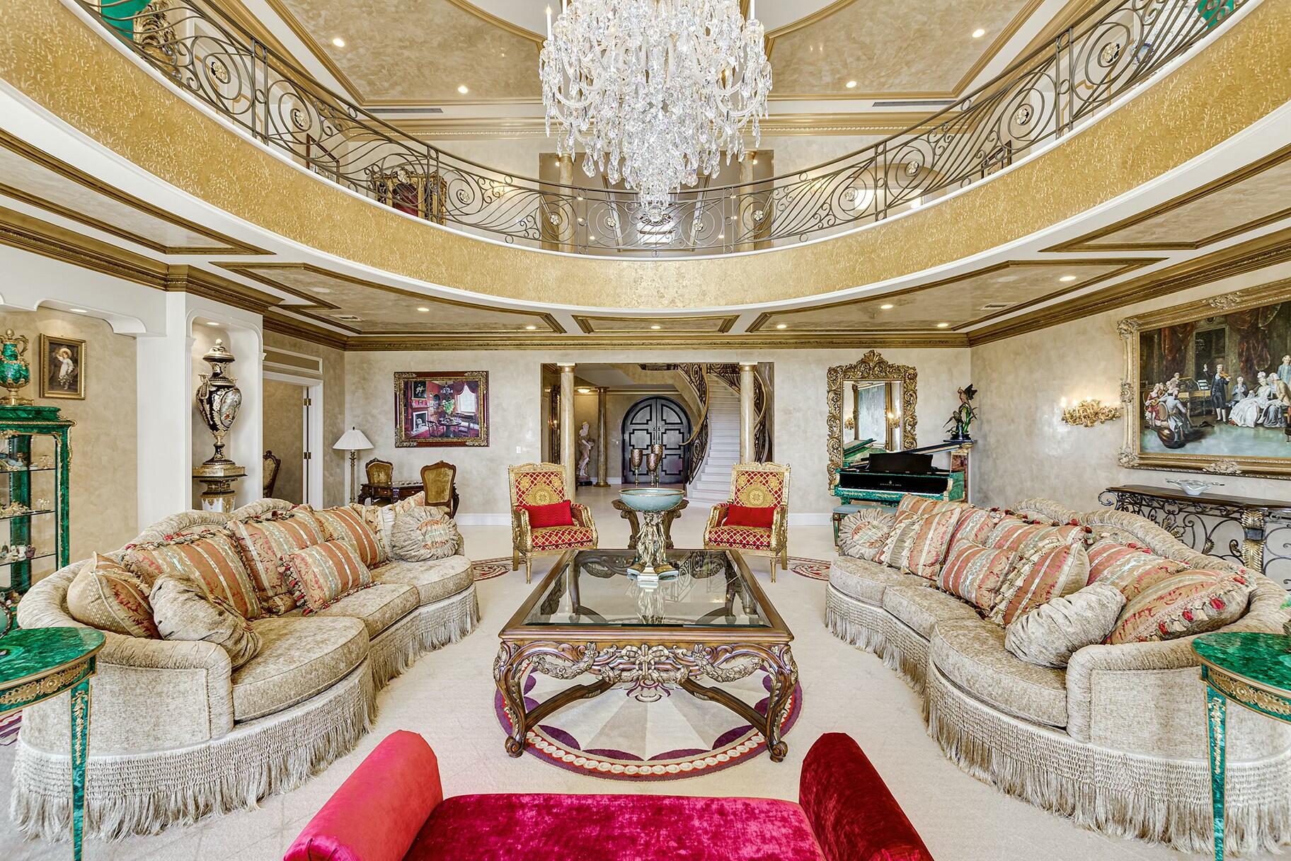 477 South Beach Road Jupiter Island, FL 33455 - Photo 14 of 54 a living room with furniture and a chandelier