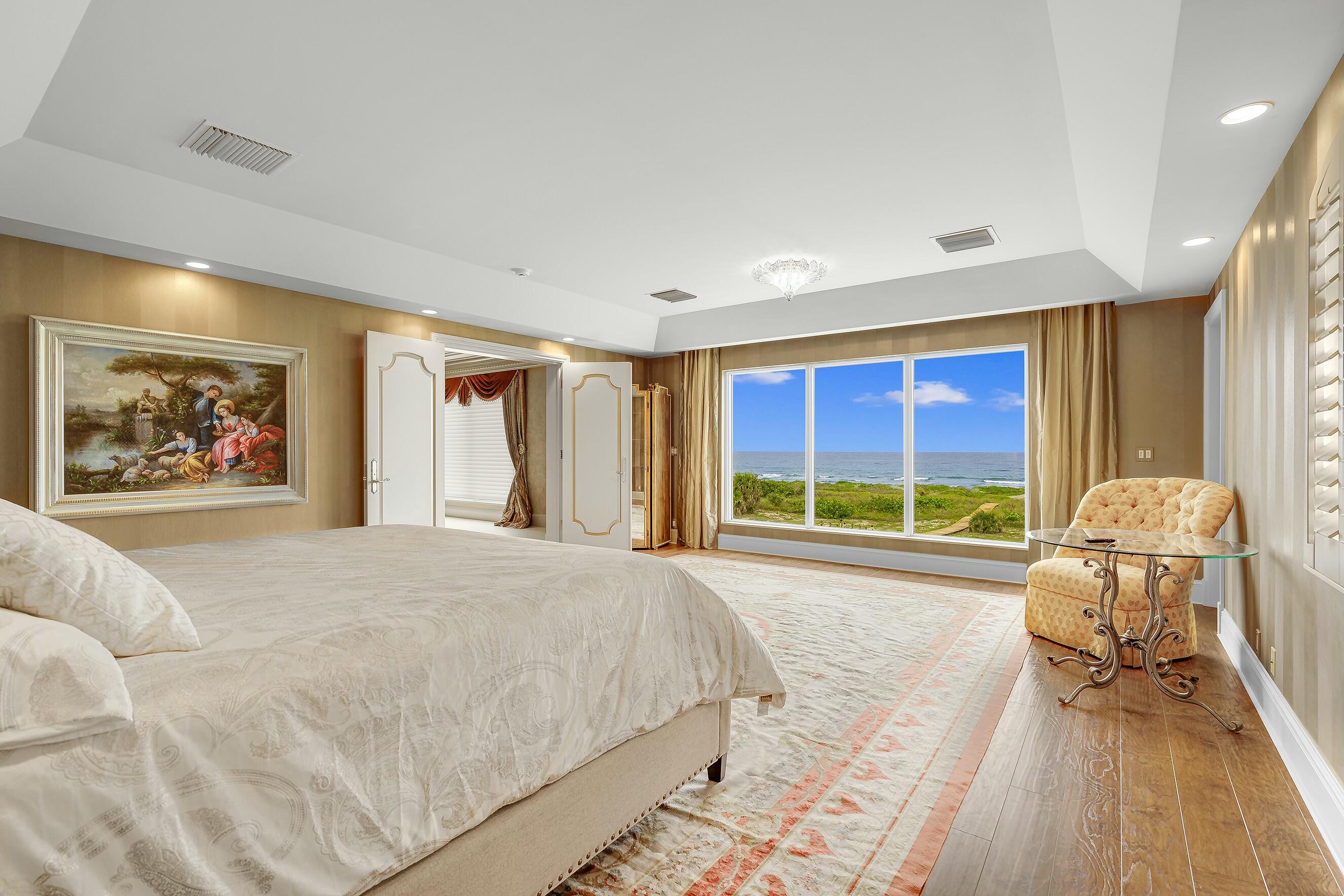 477 South Beach Road Jupiter Island, FL 33455 - Photo 21 of 54 a spacious bedroom with a large bed and a large window