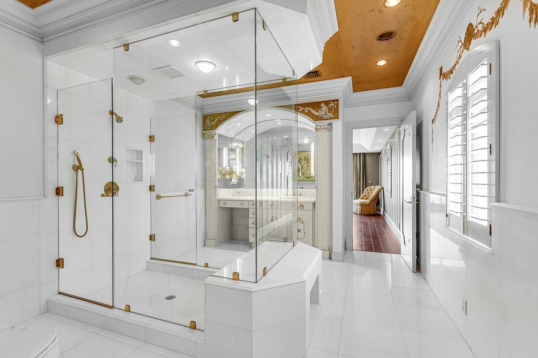 477 South Beach Road Jupiter Island, FL 33455 - Photo 23 of 54 a bathroom with a tub shower and mirror