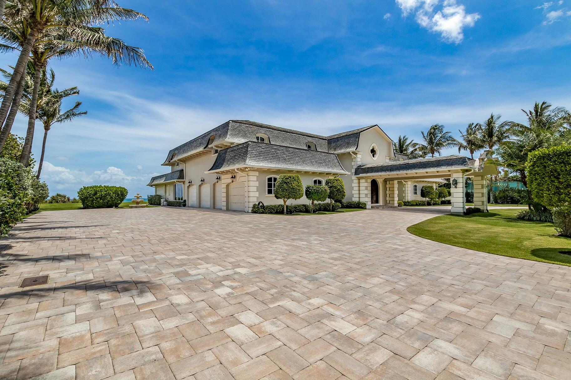 477 South Beach Road Jupiter Island, FL 33455 - Photo 35 of 54 a front view of a house with a yard