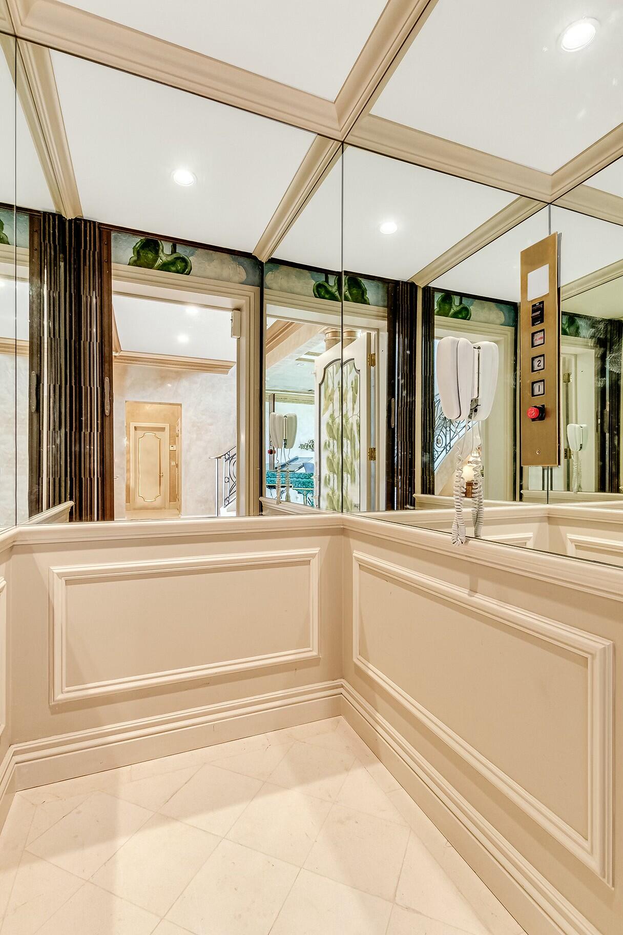 477 South Beach Road Jupiter Island, FL 33455 - Photo 38 of 54 a view of a bathroom with a tub and a large window