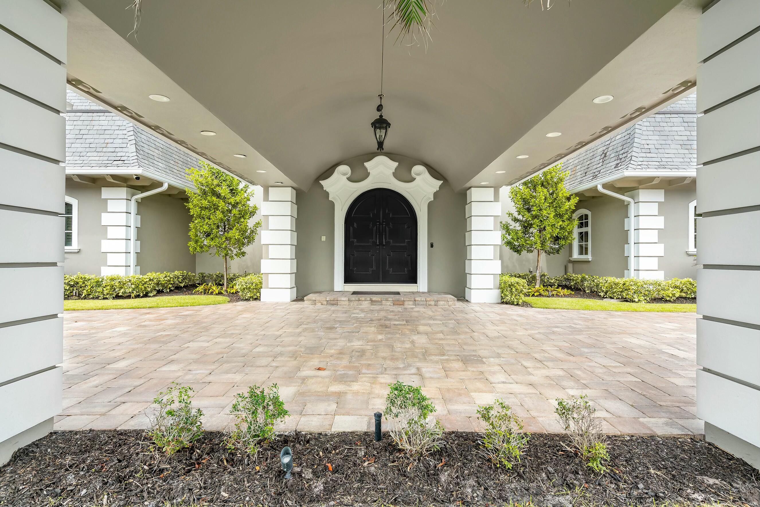 477 South Beach Road Jupiter Island, FL 33455 - Photo 51 of 54 a view of a house with a porch