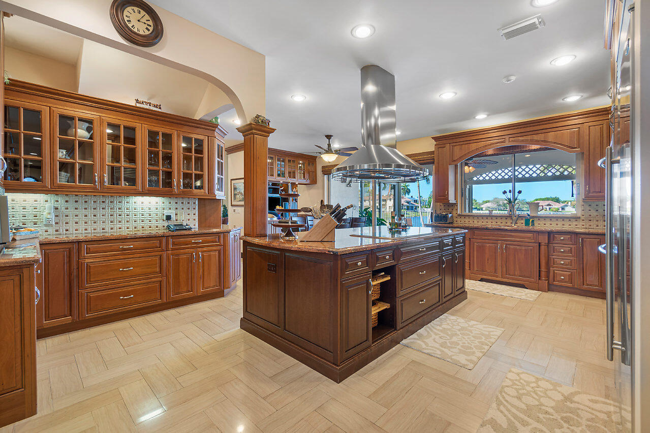 4407 Woodfield Boulevard Boca Raton, FL 33434 - Photo 14 of 37 a kitchen with stainless steel appliances granite countertop a stove and a sink