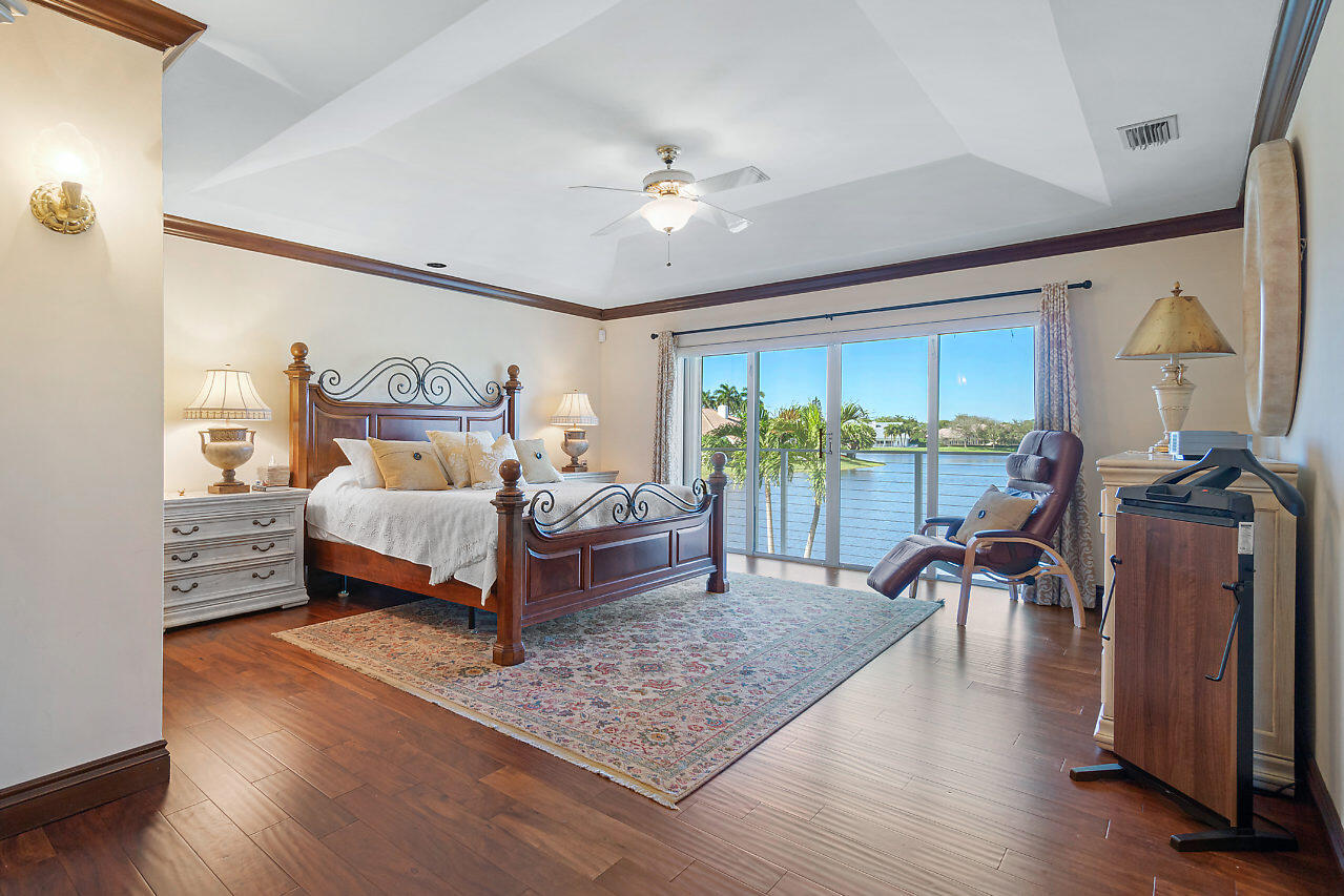 4407 Woodfield Boulevard Boca Raton, FL 33434 - Photo 16 of 37 a bedroom with furniture and a large window