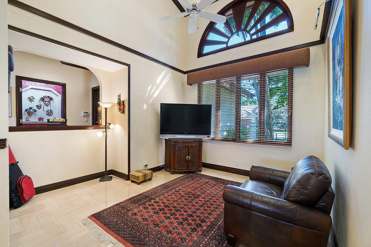 4407 Woodfield Boulevard Boca Raton, FL 33434 - Photo 24 of 37 a living room with furniture and a flat screen tv
