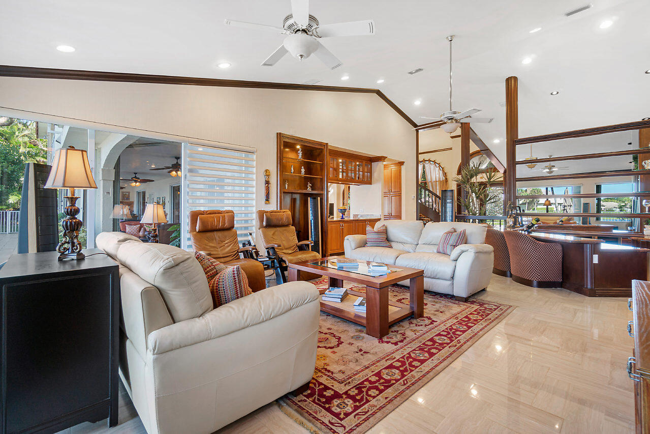 4407 Woodfield Boulevard Boca Raton, FL 33434 - Photo 10 of 37 a living room with fireplace furniture and a large window