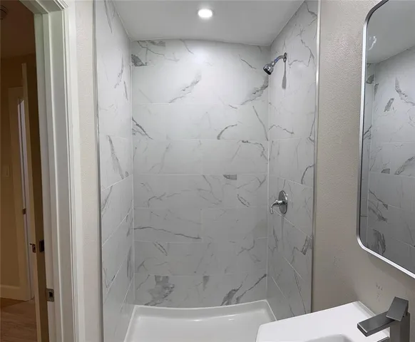 a bathroom with a shower and a toilet