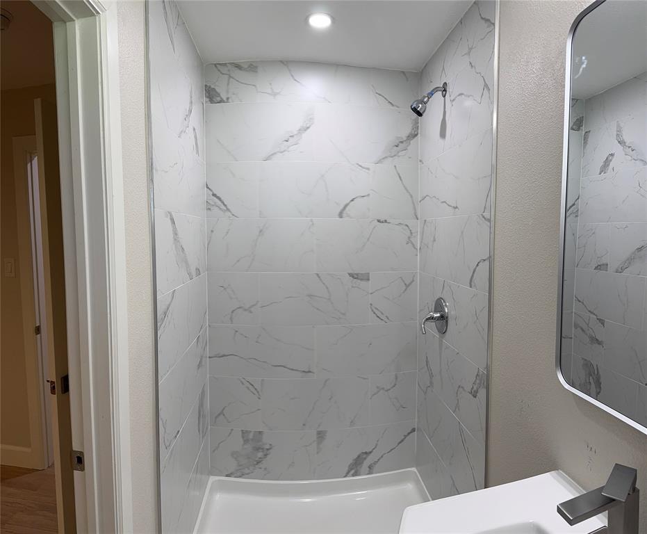 504 Pecan Street Crowley, TX 76036 - Photo 13 of 18 Bathroom featuring a tile shower and a sink