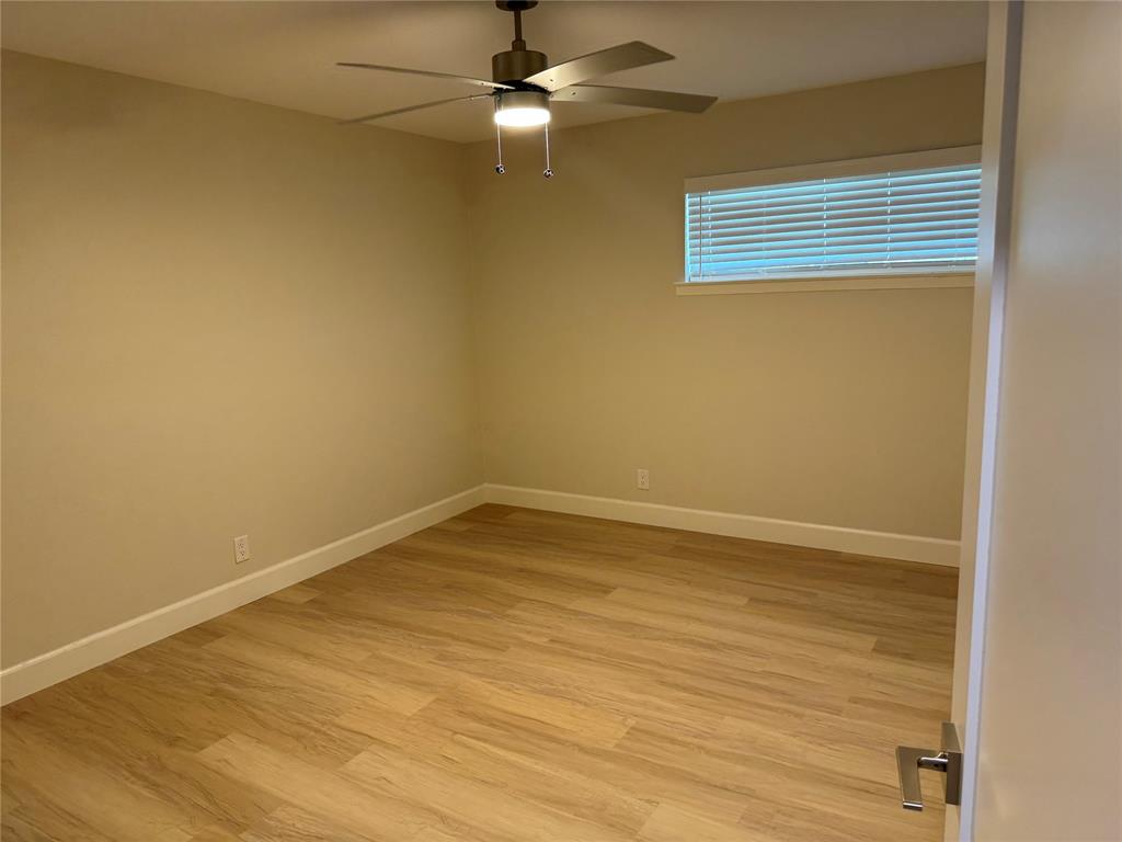 504 Pecan Street Crowley, TX 76036 - Photo 14 of 18 Unfurnished room with light wood-style flooring and a ceiling fan