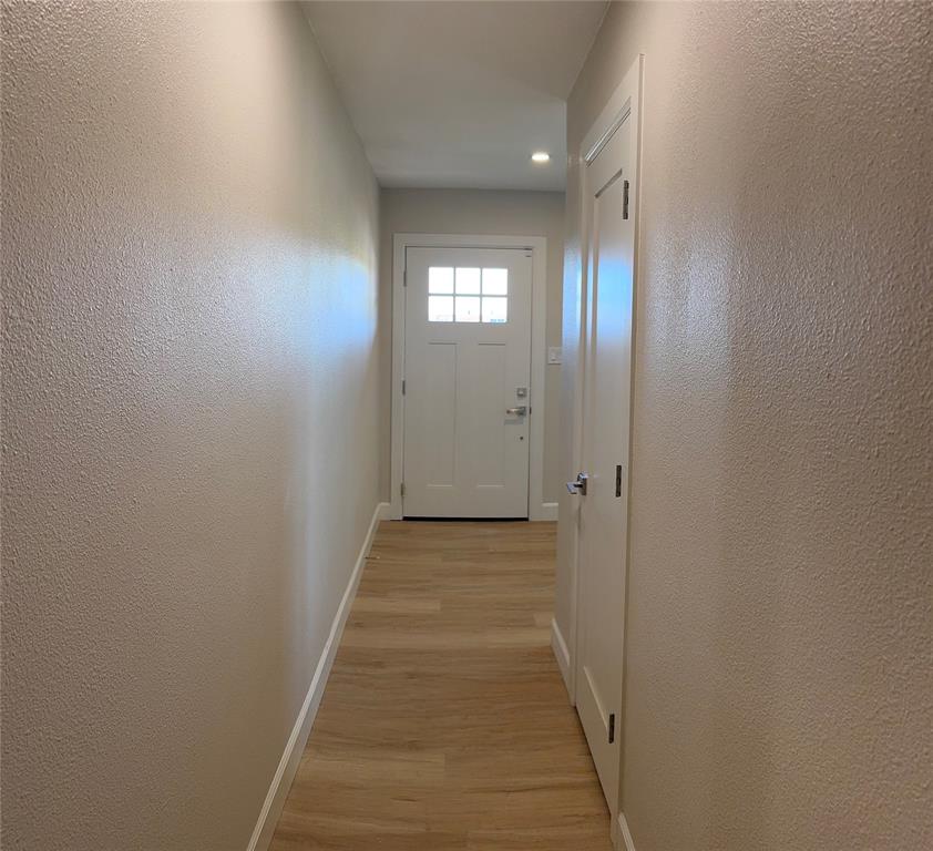 504 Pecan Street Crowley, TX 76036 - Photo 17 of 18 Entryway with a textured wall and light wood-style flooring