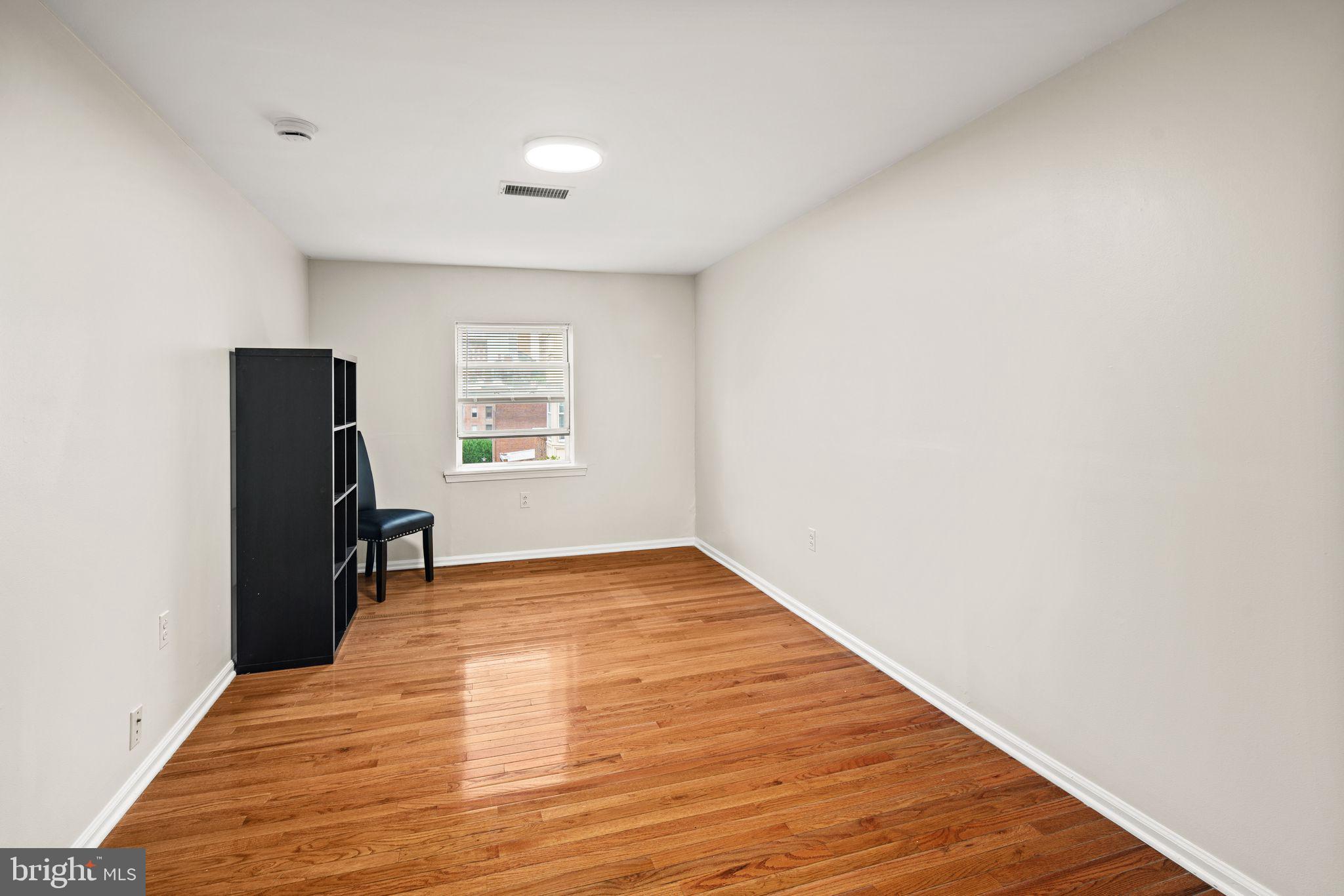 303 South 11th Street, Unit 9 Philadelphia, PA 19107 - Photo 13 of 36 a view of empty room with wooden floor and fan