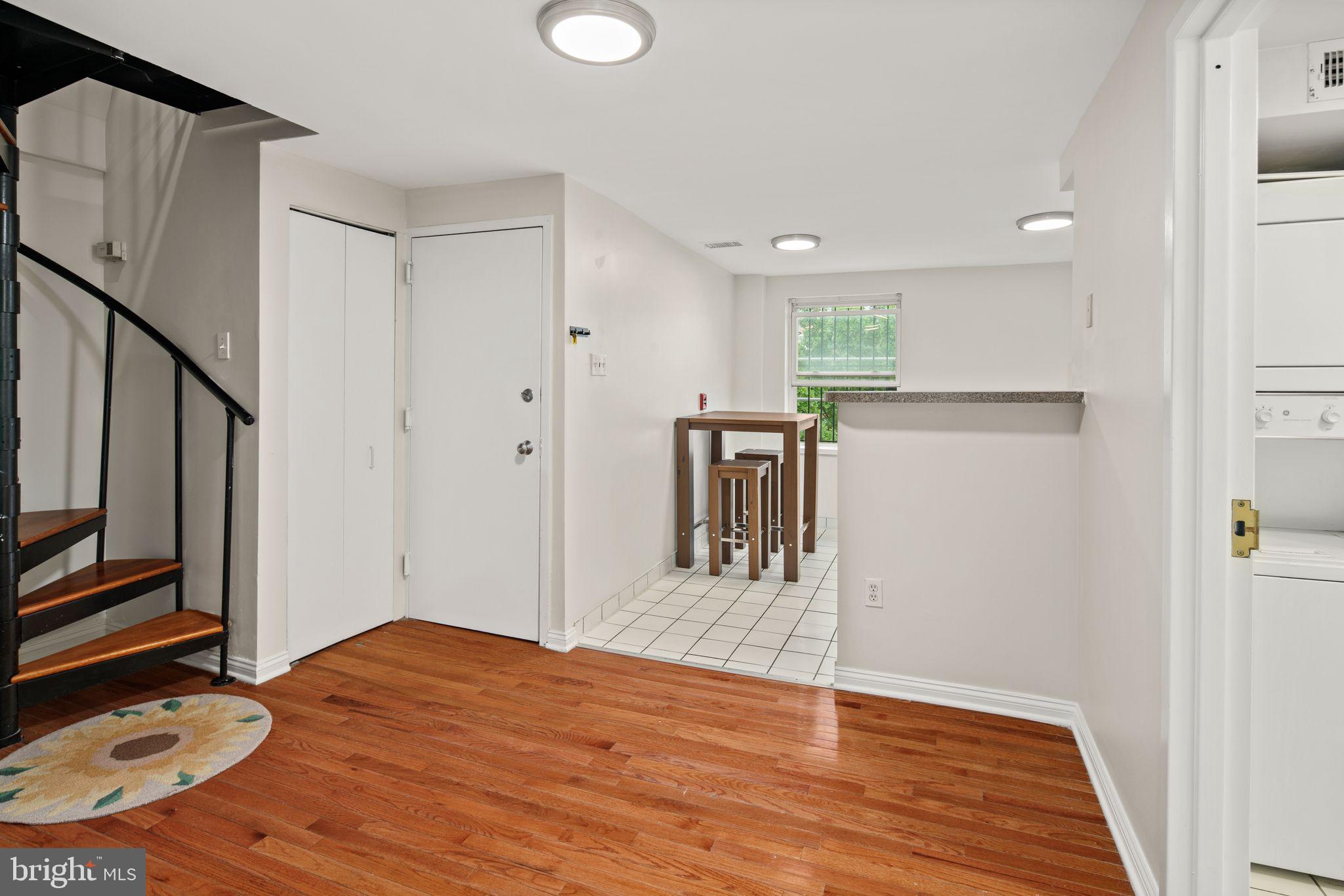 303 South 11th Street, Unit 9 Philadelphia, PA 19107 - Photo 22 of 36 a view of a kitchen with wooden floor and a sink