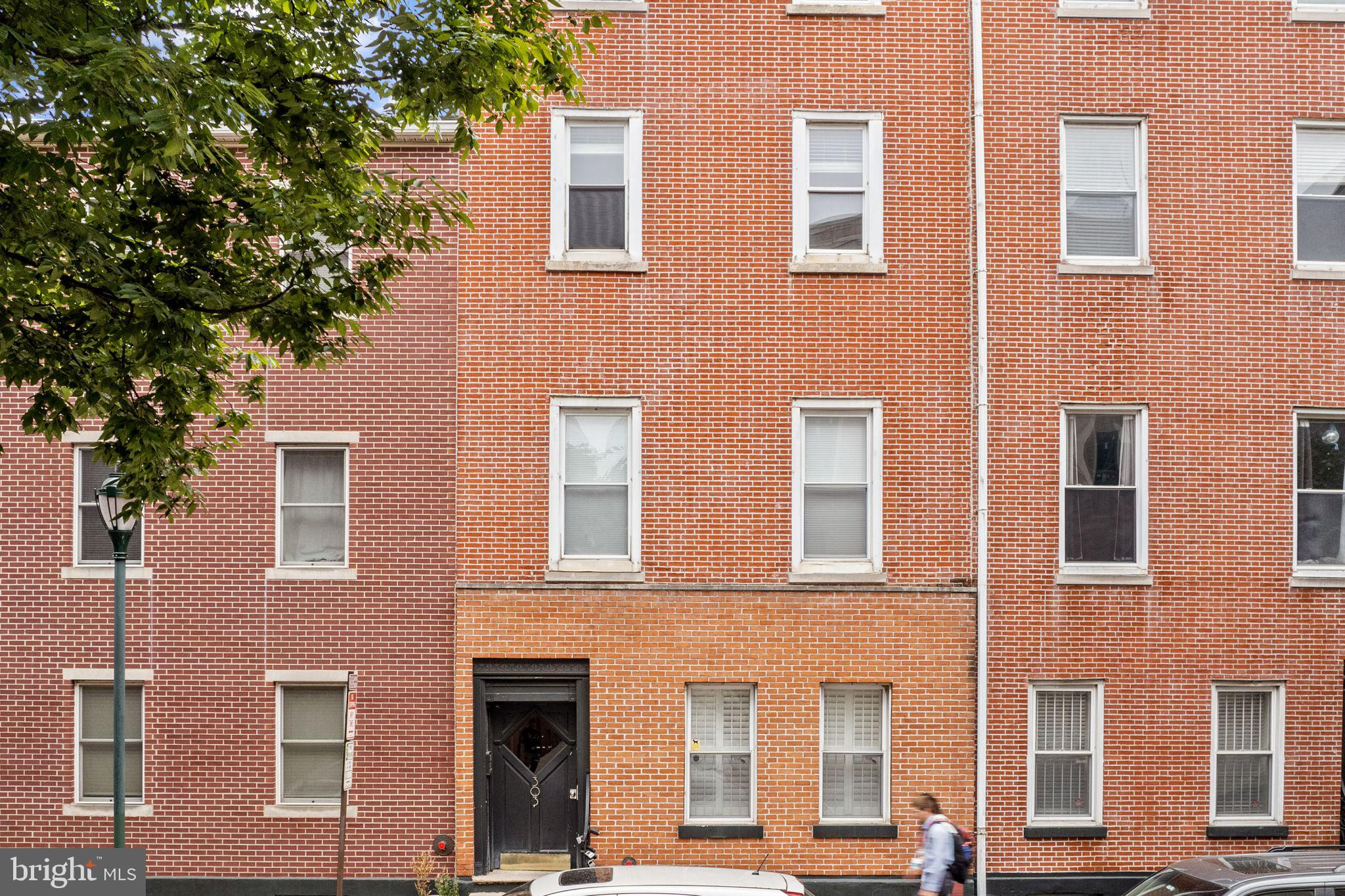 303 South 11th Street, Unit 9 Philadelphia, PA 19107 - Photo 4 of 36 a front view of a building with a tree