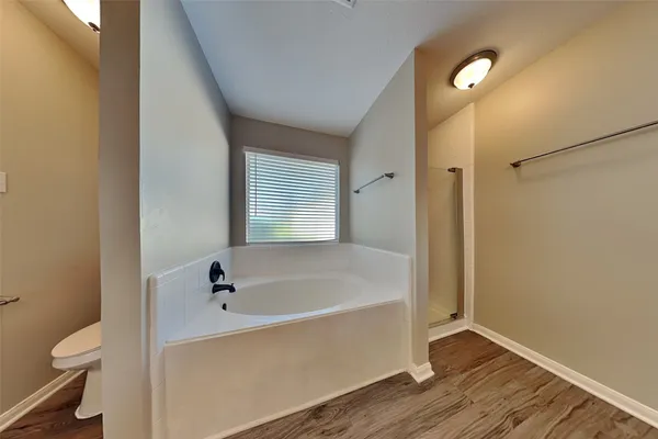 a white bath tub sitting next to a toilet