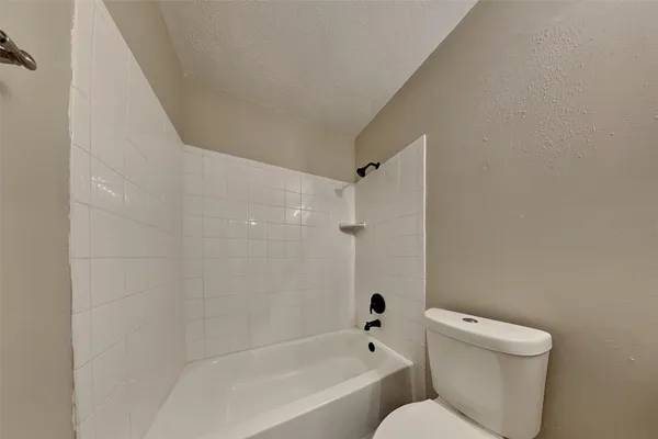 a bathroom with a toilet and a bathtub