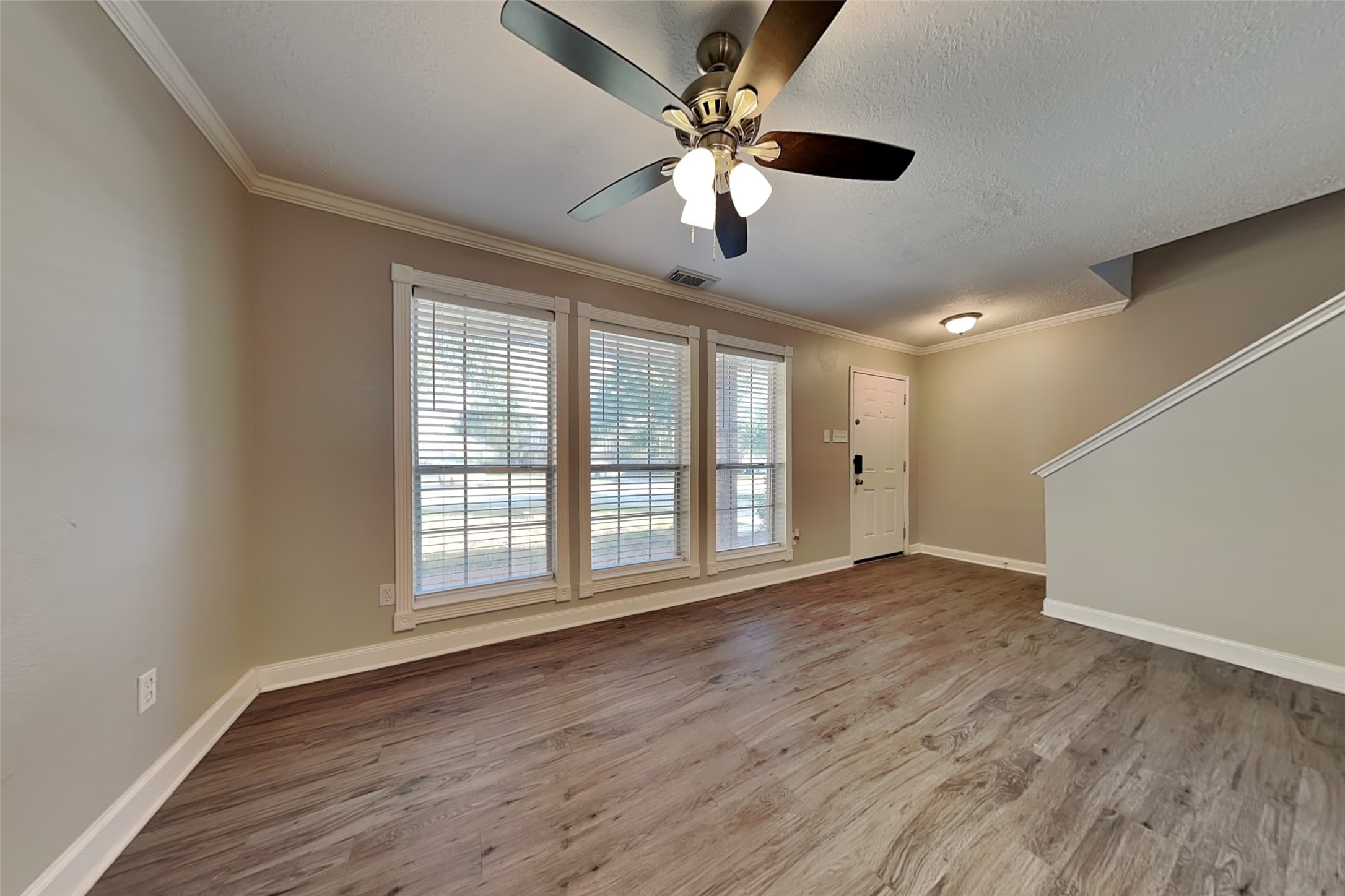 29439 Fox River Drive Spring, TX 77386 - Photo 3 of 29 a view of an empty room with wooden floor and a window