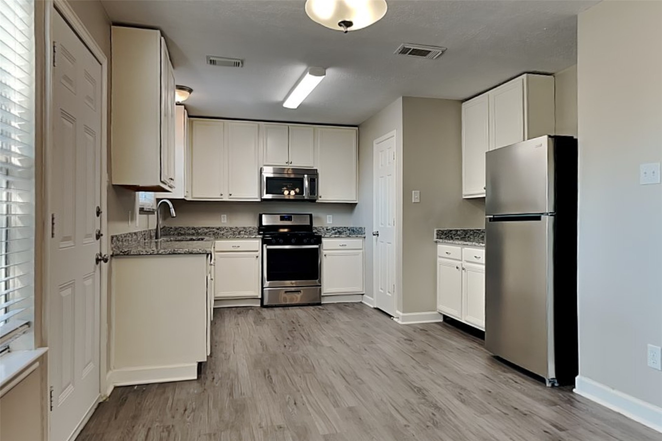 29439 Fox River Drive Spring, TX 77386 - Photo 7 of 29 a kitchen with stainless steel appliances a refrigerator stove and microwave