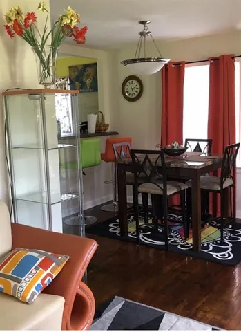 a living room with a table chairs and a fireplace