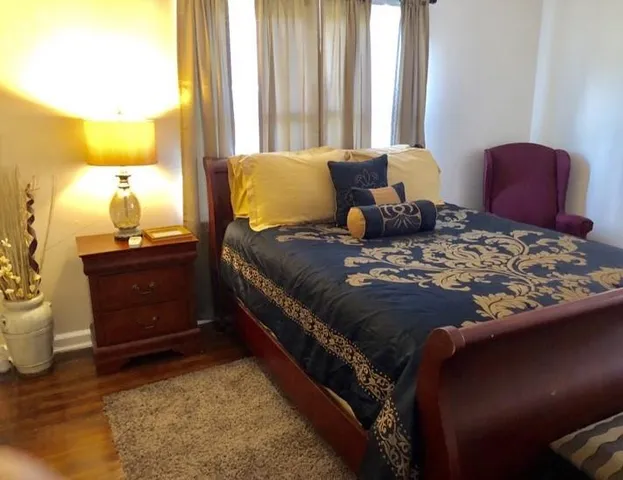 a bedroom with a bed and a dresser