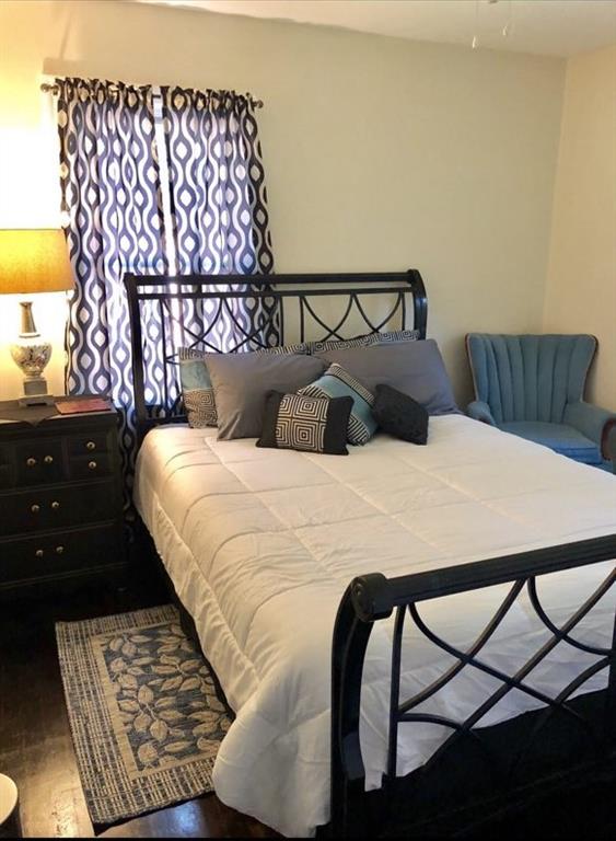 1839 Penelope Road Northwest Atlanta, GA 30314 - Photo 6 of 10 a bedroom with a bed a dresser and a night stand