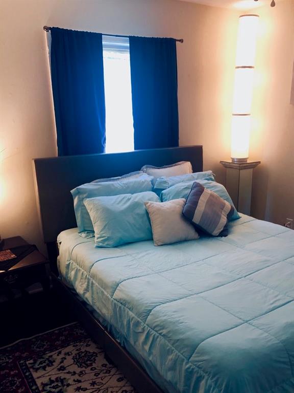 1839 Penelope Road Northwest Atlanta, GA 30314 - Photo 8 of 10 a bedroom with a bed and wooden floor