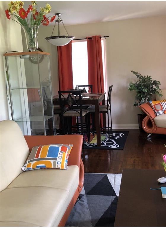 1839 Penelope Road Northwest Atlanta, GA 30314 - Photo 9 of 10 a living room with furniture rug and wooden floor