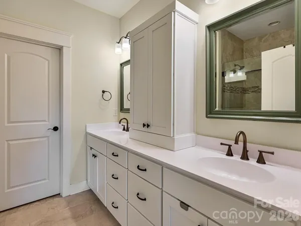 a bathroom with a double vanity sink and mirror