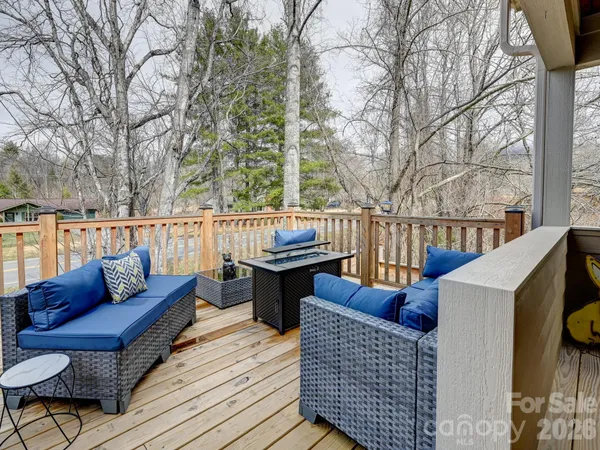 a roof deck with couches and wooden fence