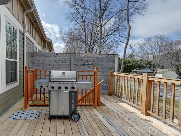 a view of a roof deck with wooden floor and fence