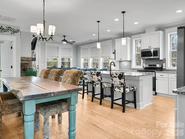 a large kitchen with a table and chairs