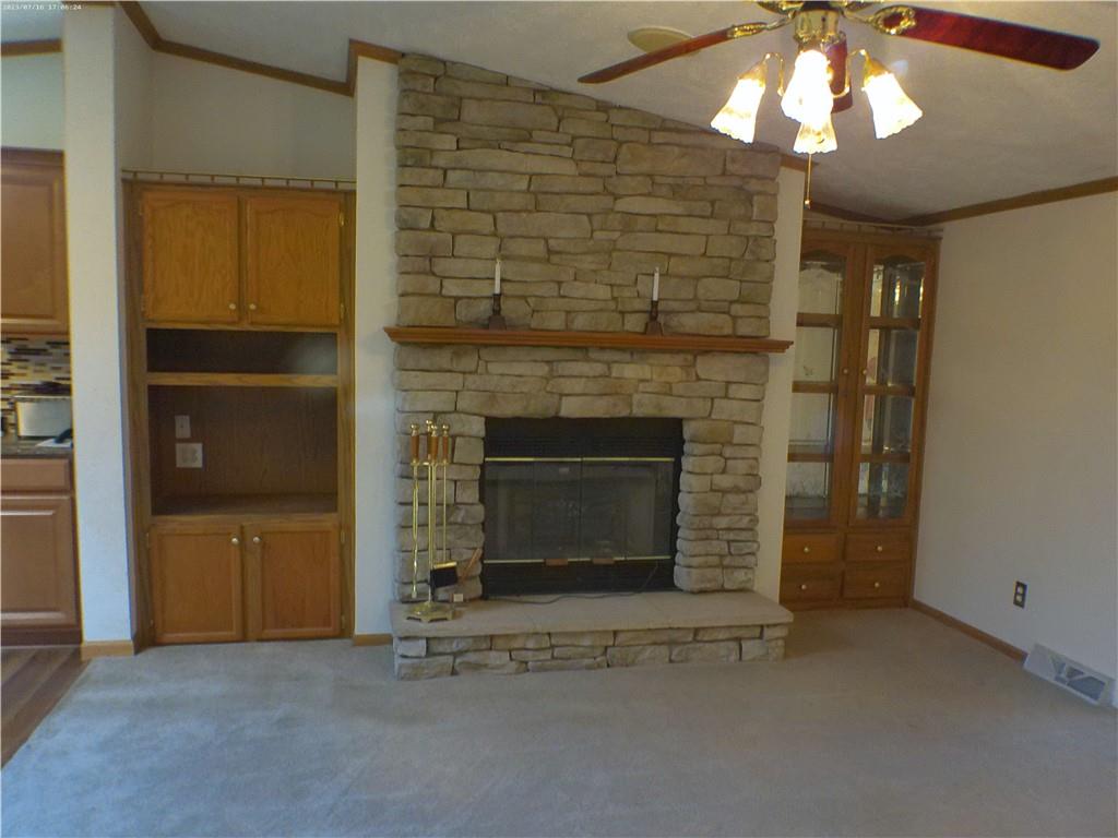 107 Hunting Hill Road Dilliner, PA 15327 - Photo 18 of 24 an empty room with a fireplace and chandelier fan