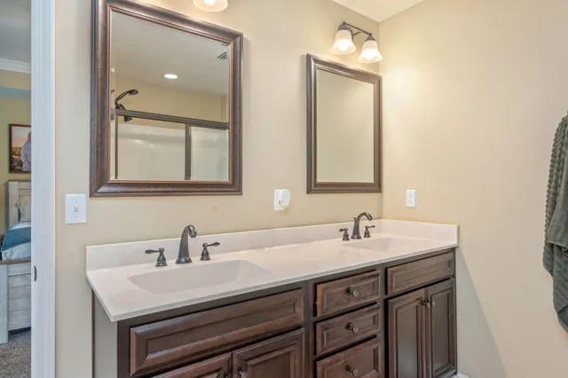 a bathroom with 2 sink and a mirror