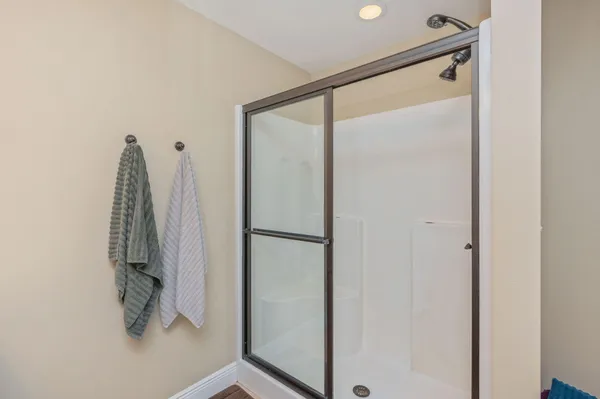 a bathroom with a shower and a glass door