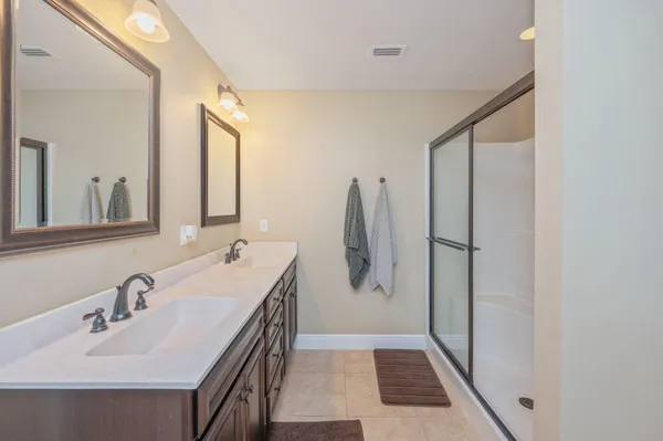 a bathroom with a double vanity sink and mirror