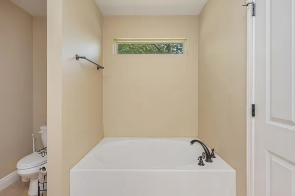 a bathroom with a bathtub and toilet