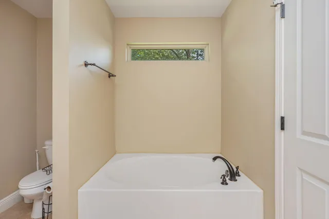 a bathroom with a bathtub and toilet