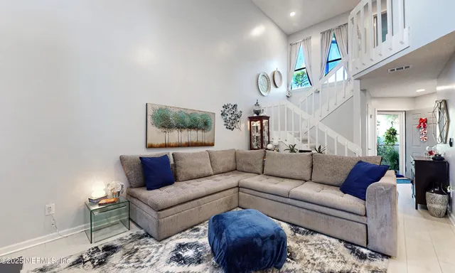 a living room with furniture and a painting