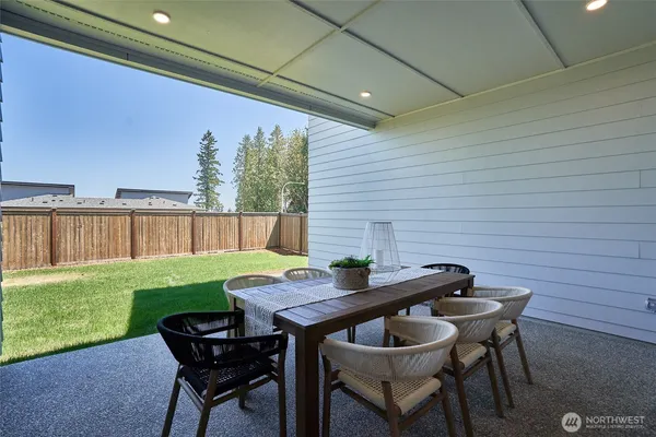 a backyard of a house with table and chairs