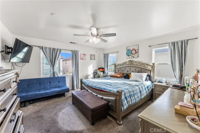 a bedroom with a bed window and a dresser