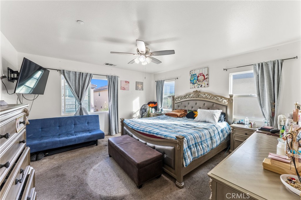 507 Villa Way Colton, CA 92324 - Photo 15 of 34 a bedroom with a bed window and a dresser