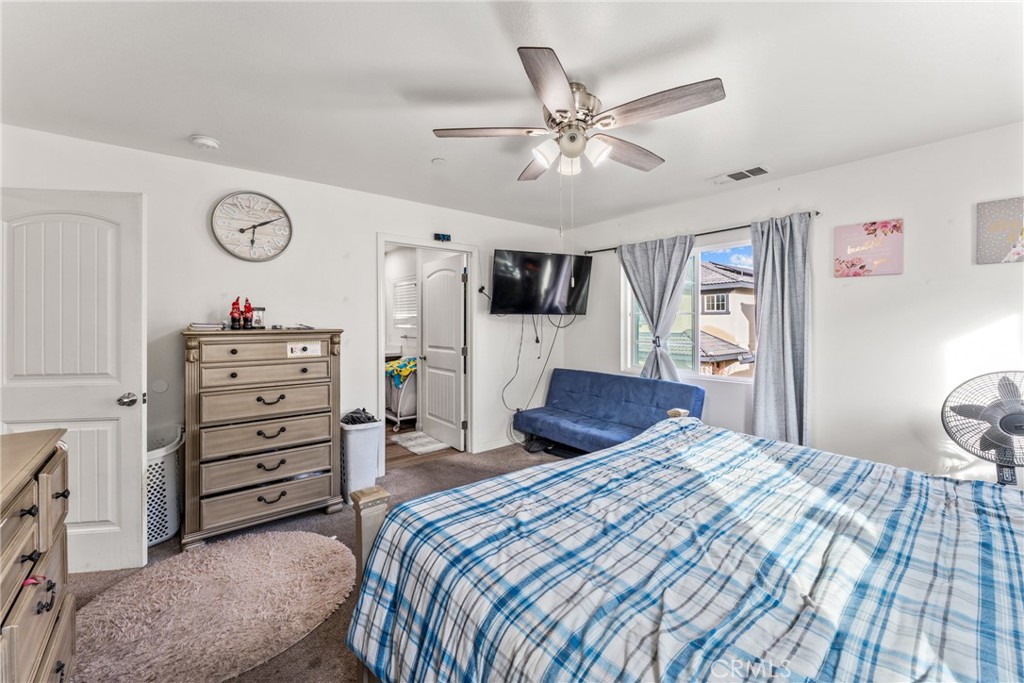 507 Villa Way Colton, CA 92324 - Photo 16 of 34 a bedroom with a bed and a chandelier