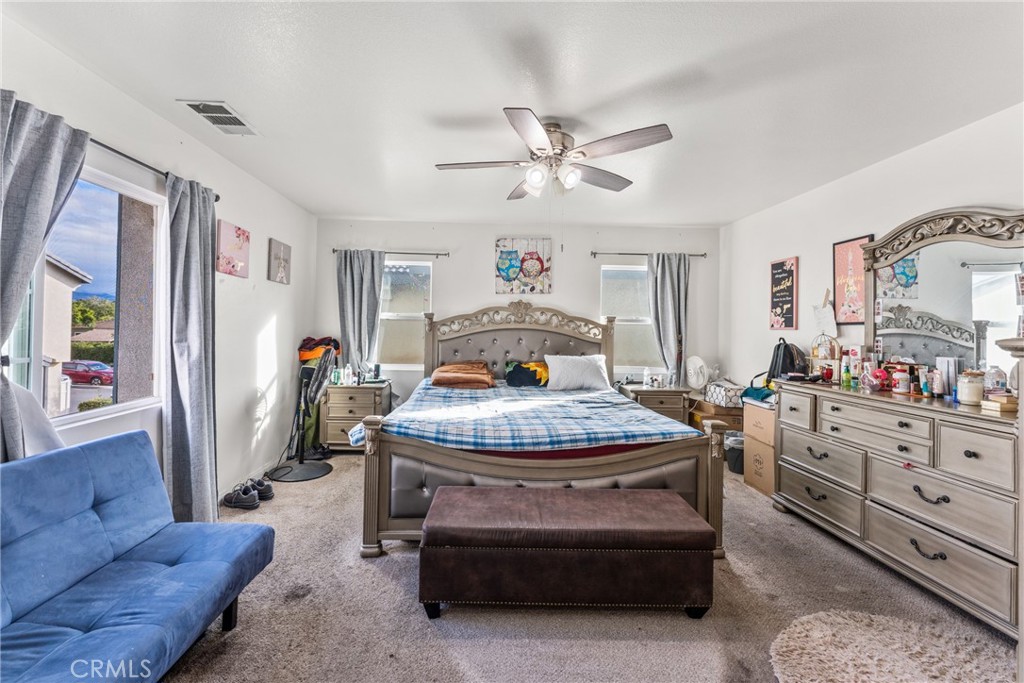 507 Villa Way Colton, CA 92324 - Photo 17 of 34 a bedroom with a bed and a chandelier