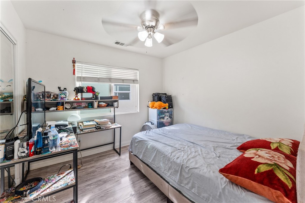 507 Villa Way Colton, CA 92324 - Photo 27 of 34 a bedroom with a bed and a bookshelf