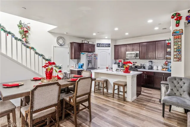 a kitchen with kitchen island granite countertop wooden cabinets and white appliances